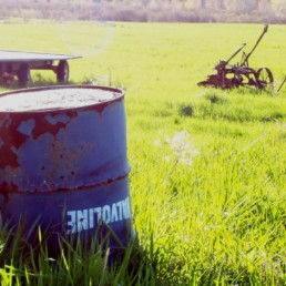 rusty barrel in field