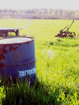 rusty barrel in field