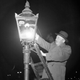 man on ladder lighting vintage street light