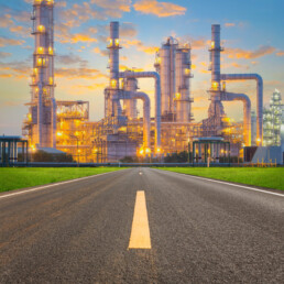 Asphalt road and oil refinery factory, twilight time.